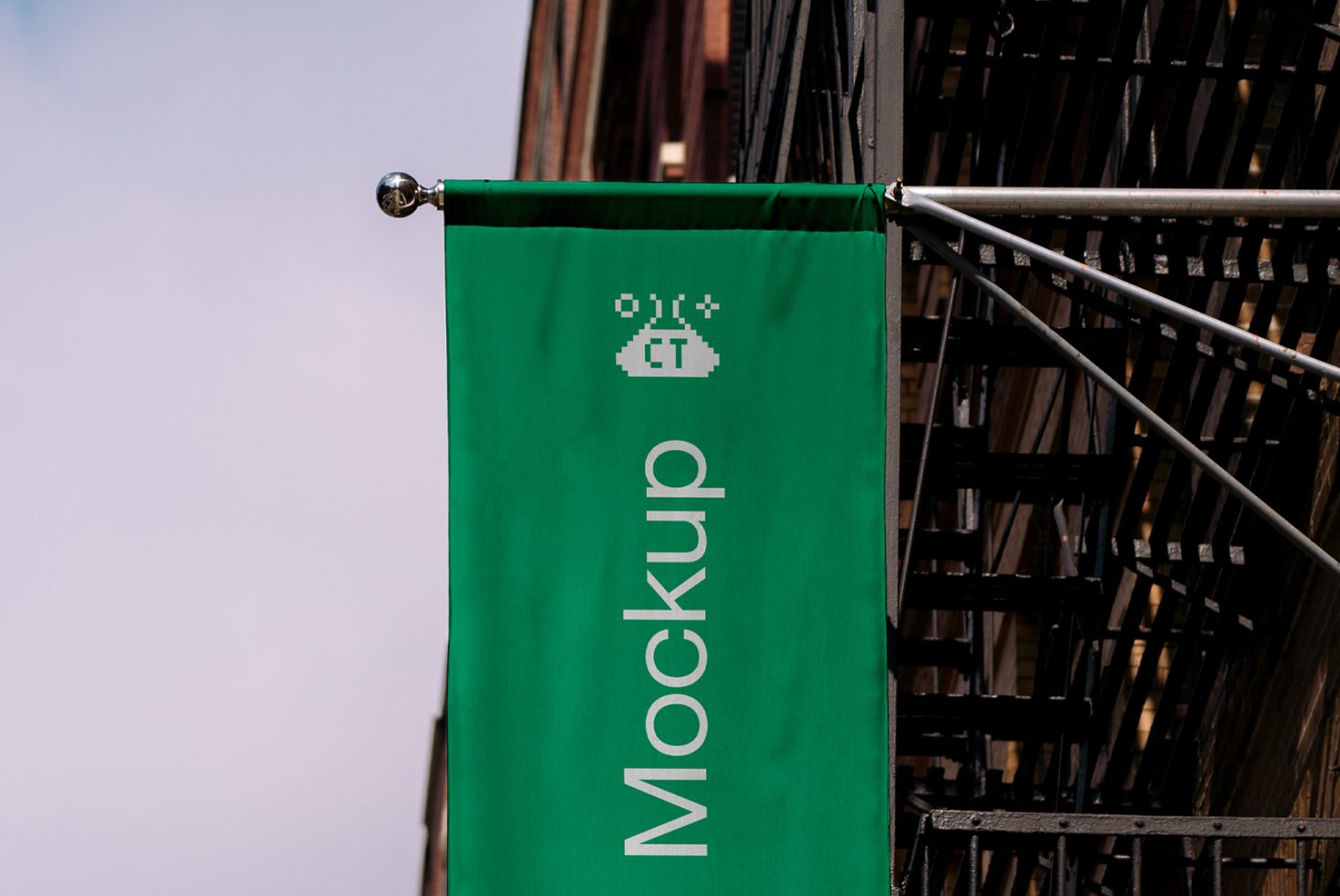 Green banner mockup hanging on a metal rod with pixelated design element, urban setting, clear fonts, ideal for branding, templates, designers.